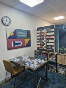 Artwork saying 'if your dreams don't care you they aren't big enough' in seating area at CFO Activity Hub